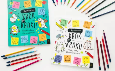 Dwie książki "Rysowanie Krok po Kroku" zachęcają do nauki rysowania smoków, robotów i zwierząt. Kolorowe kredki leżą obok, gotowe do tworzenia.