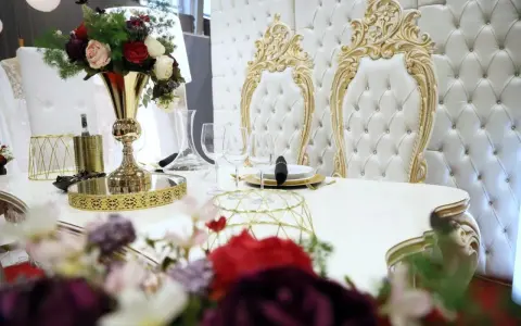 Elegancki stół z kwiatami i złotymi zdobieniami. Czy za ślub cywilny się płaci? Tutaj wszystko wygląda na luksusowe.