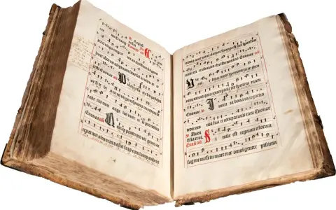 An ancient illuminated manuscript, its pages filled with musical notation and text, evokes the divine hours.