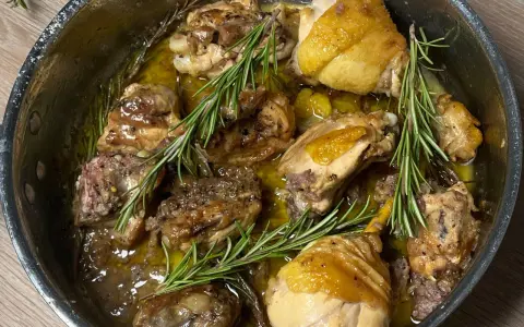 Succulento pollo alla cacciatora in bianco, cotto lentamente in padella con erbe aromatiche e un sughetto dorato.