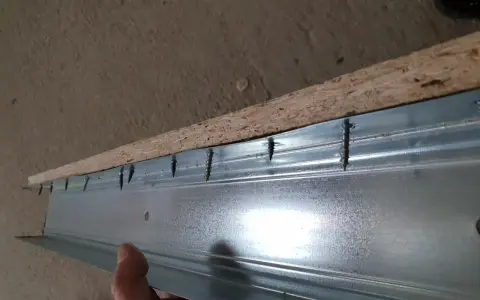 Schrauben verbinden OSB-Platte mit Metallprofil. Rigips auf OSB schrauben ist der nächste Schritt.