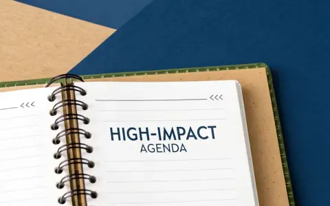 A notebook open to a page titled "HIGH-IMPACT AGENDA," ready for a productive board meeting.