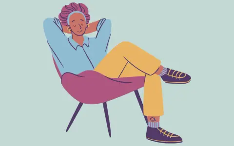 A person relaxes in a chair, hands behind their head, demonstrating how to decompress.