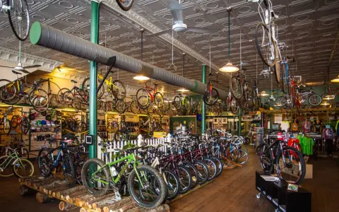 A bike shop interior, showcasing a wide selection of bicycles, from road bikes to mountain bikes, offering advice on how to choose a mountain bike.