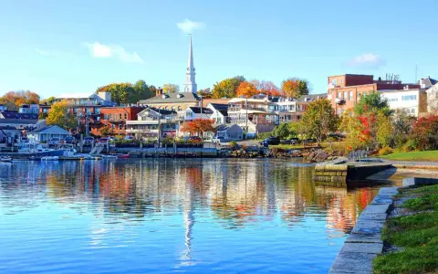 A charming New England harbor town with colorful autumn foliage, perfect for weekend getaways.