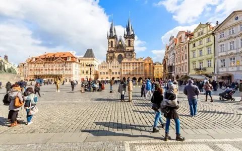 People enjoy Prague tours in Old Town Square, with the Church of Our Lady before Týn dominating the skyline.