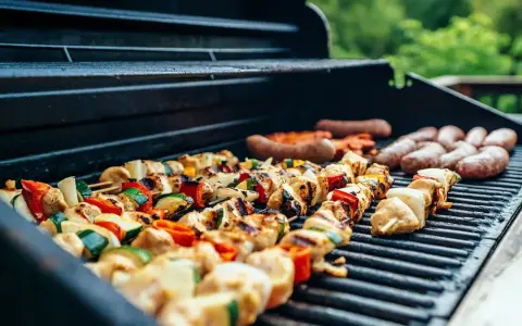 Brochettes de poulet et légumes, saucisses en cuisson barbecue gaz. L'été arrive, les grillades sont prêtes !
