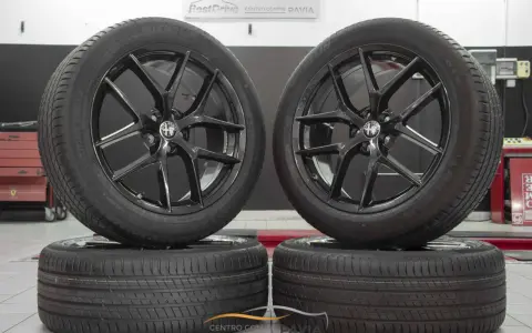 Cerchi in lega neri lucidi con logo Alfa Romeo, perfetti per un'Alfa Romeo Stelvio. Gomme Michelin Latitude Sport 3.