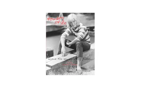 A woman with short blonde hair embodies tomboy style, wearing a striped shirt and jeans, sitting on a wooden beam. Text reads "tomboy style" and "beyond the boundaries of fashion.