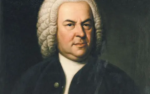 Portret Jana Sebastiana Bacha w peruce i czarnym stroju. Mistrz barokowej muzyki spogląda z obrazu zamyślony.