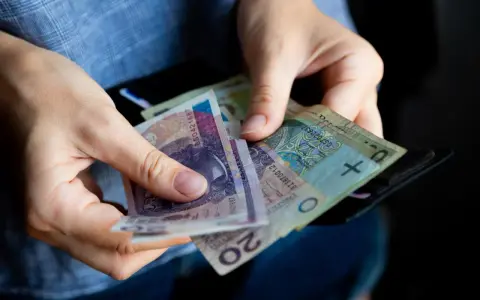 Ręce liczą banknoty, zastanawiając się, ile lat pracy do emerytury.