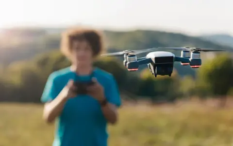 A person controls a drone, unaware of the potential penalty for flying a drone without a license.