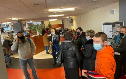 Kolejka ludzi w biurze paszportowym w Częstochowie. Niektórzy mają maseczki.