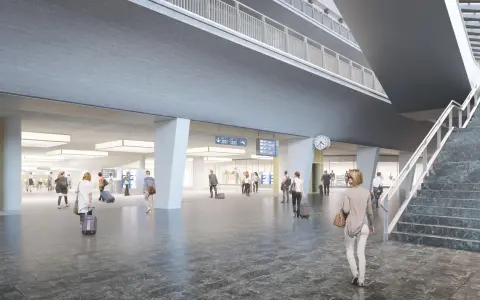 Modern, spacious interior of the Lucerne train station with travelers and digital departure boards.