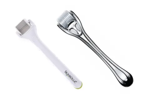 Dos rodillos para microneedling capilar, uno blanco y otro plateado, listos para estimular el crecimiento del cabello.