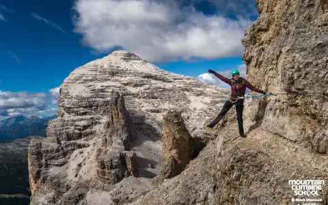 Kobieta na via ferrata, pokonująca skalną ścieżkę z ubezpieczeniem. To właśnie jest ferrata co to za przygoda!