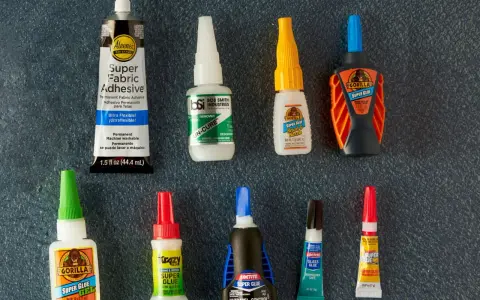 A collection of super glue bottles, including Gorilla Glue and Krazy Glue, are laid out for a comparison of bondic vs super glue.