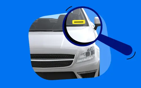 Lupe über dem Auto, die auf eine gelbe Markierung am Armaturenbrett zeigt. Das erklärt, was bedeutet FIN beim Auto.