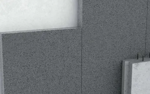 Detalle de un muro con hormigón aislante térmico, mostrando capas y textura granular.