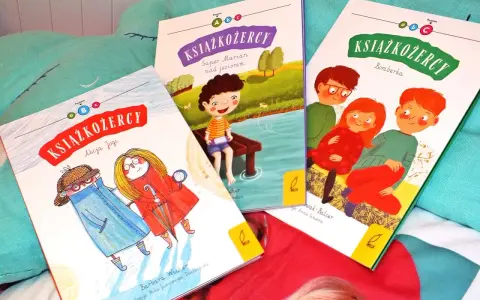 Trzy okładki książek z serii "Książkożercy" na miękkim, turkusowym tle. Dwie dziewczynki i chłopiec, bohaterowie przygód, zapraszają do czytania.