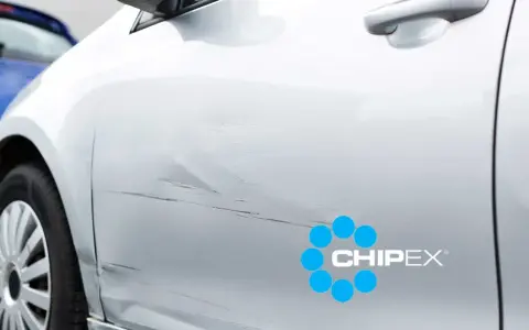 Scratches on a silver car door, with a CHIPEX logo. Can you buff out scratches like these?