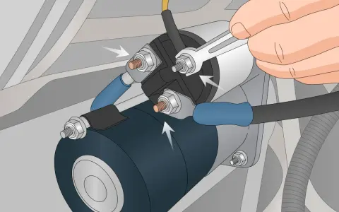 A hand uses a wrench to tighten a bolt on a car's starter solenoid. This could be a fix for bad solenoid symptoms like clicking sounds or a no-start condition.