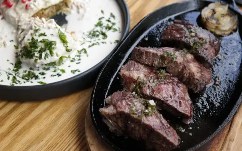 En saftig argentinsk grillfest med perfekt stekt kött och en krämig rätt med örter.
