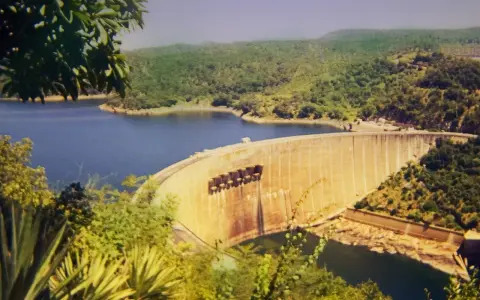 Ogromna zapora na jeziorze Kariba, otoczona bujną zielenią, tworzy imponujący krajobraz.