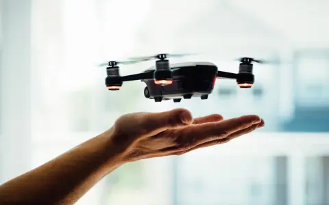 A drone hovers over an open hand, a visual metaphor for understanding Pennsylvania drone laws before takeoff.