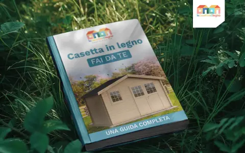 Guida completa su come costruire una cassetta in legno fai da te. Immagine di un libro aperto sull'erba con la copertina che mostra una casetta di legno.