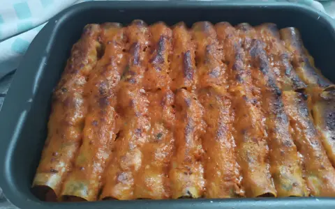 Cannelloni di carne ricetta della nonna, cotti al forno e ricoperti di sugo rosso e formaggio fuso.