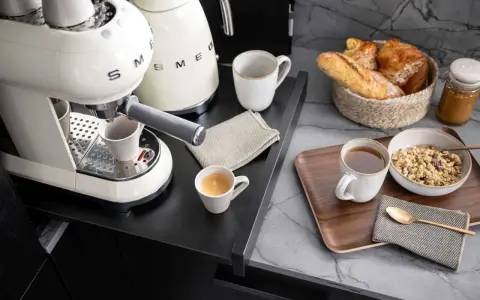 Kaffeebar zu Hause einrichten: Espresso, Müsli und Gebäck auf einem Tablett.