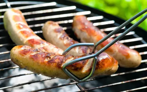 Bratwurst grillen: Saftige Würste brutzeln auf dem Rost, bereit für den Genuss.