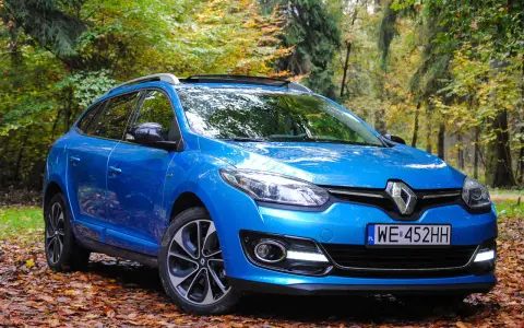 Niebieski Renault Megane 2 1.6 16v na tle jesiennego lasu.