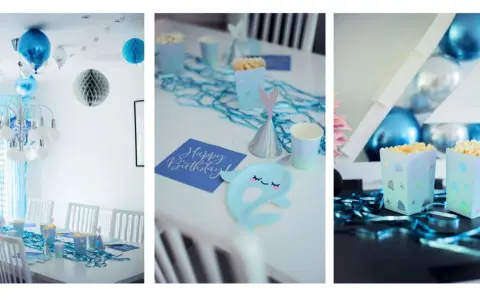 Blå och silverfärgade ballonger, stjärnor och honkoms dekorationer skapar en festlig stämning. Bordet är dukat med havstema, inklusive popcornaskar och en "Happy Birthday"-servett.