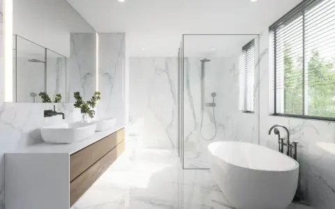Salle de bain moderne avec baignoire îlot, double vasque et douche vitrée. La faïence marbrée blanche illumine l'espace, créant une ambiance épurée et luxueuse.