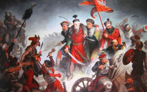 Obraz przedstawia zaciętą bitwę pod Kłuszynem 1610. Polscy żołnierze walczą z wrogiem, wznosząc sztandar z orłem.