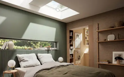 Chambre paisible avec mur vert sauge. Le vert s'harmonise avec le bois clair et le lin, créant une ambiance douce.