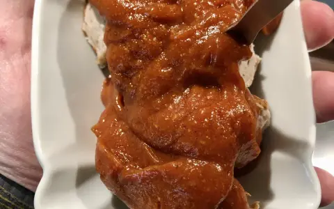 Eine Portion Currywurst mit viel Sauce, die Lust auf das Currywurst Rezept macht.