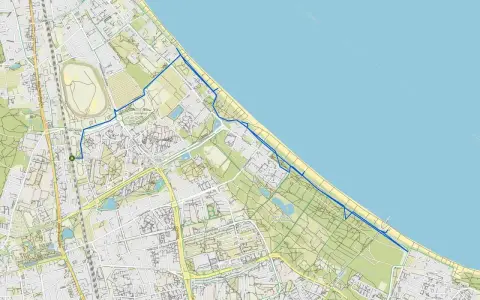 Mapa z zaznaczoną trasą rowerową wzdłuż wybrzeża. Nadmorska trasa rowerowa Trójmiasto prowadzi przez tereny zielone i miejskie.