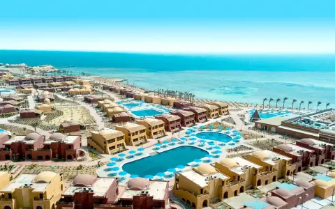 Widok z lotu ptaka na kompleks hotelowy Pickalbatros w Marsa Alam. Wiele budynków z kopułami, baseny i plaża nad Morzem Czerwonym.