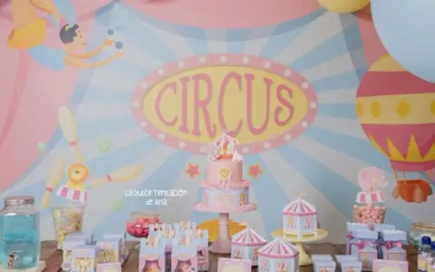 Una fiesta temática de circo para niños con pastel, globos y dulces.