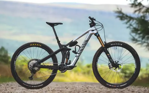 A silver Canyon enduro mountain bike with full suspension, ready to tackle any trail.