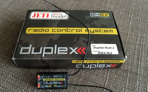 Jeti Duplex Rsat 2 Satellitenempfänger und die Verpackung des Jeti Duplex 2.4EX Funksystems.