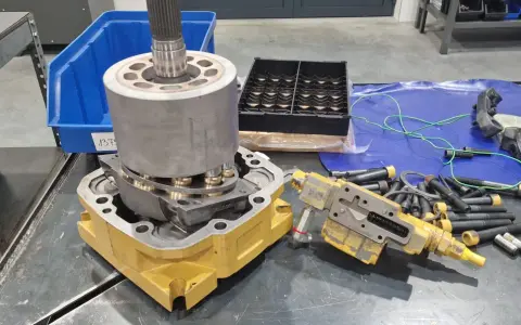Rozłożone części do naprawy pomp wodnych. Widać elementy hydrauliczne, wał, obudowę i śruby.