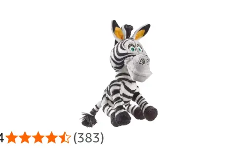 Pluszowa zebra z Madagaskaru, Marty, siedzi z szeroko otwartymi oczami i uśmiechem.