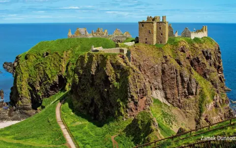 Ruiny zamku Dunnottar na klifie w Szkocji, majestatycznie górujące nad błękitnym morzem.