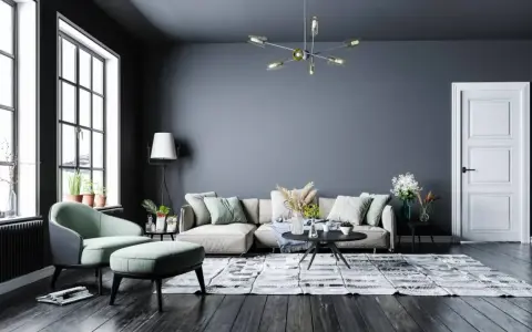 Nowoczesny salon z szarą ścianą, beżową kanapą i miętowym fotelem. Inspiracje kolory dla Twojego wnętrza.
