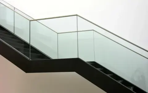Escalera moderna con barandillas de cristal. ¿Cómo saber si un cristal es templado? La seguridad es clave.