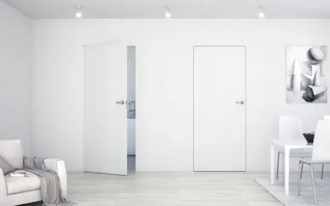 Minimalistyczne wnętrze z drzwiami Sara Eco. Jasna sofa, stół z krzesłami i obraz na ścianie.